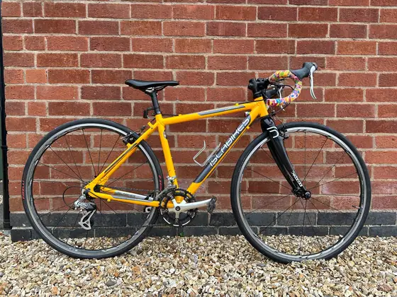 Orange steel-framed road bike with modern groupset